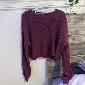 Purple knit sweater. Partly cropped.